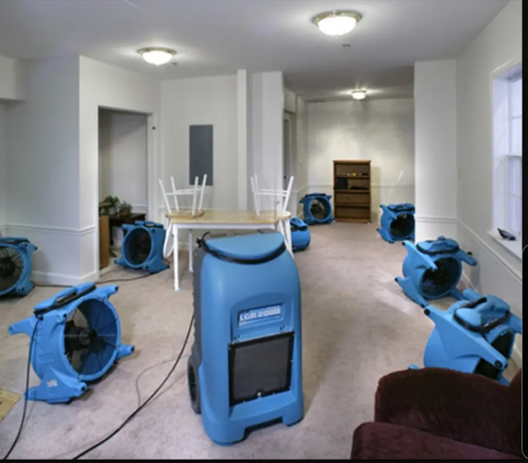 Air movers and dehumidifier setup for Water Damage Restoration in Phelps